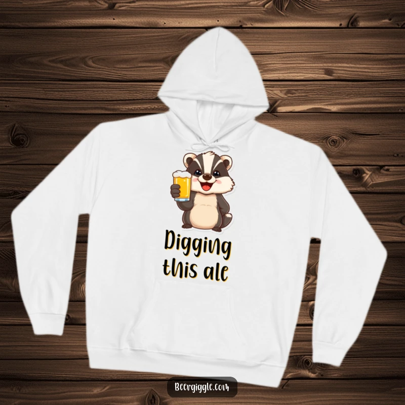 Funny hoodie featuring a delighted badger character toasting with a beer, perfect for staying warm and celebrating in humorous style.