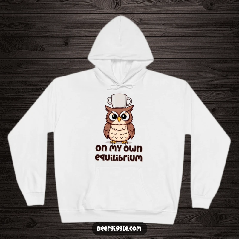 Funny tipsy owl hoodie showcasing a character with a mug precariously balanced on its head, designed for comfort and amusement.